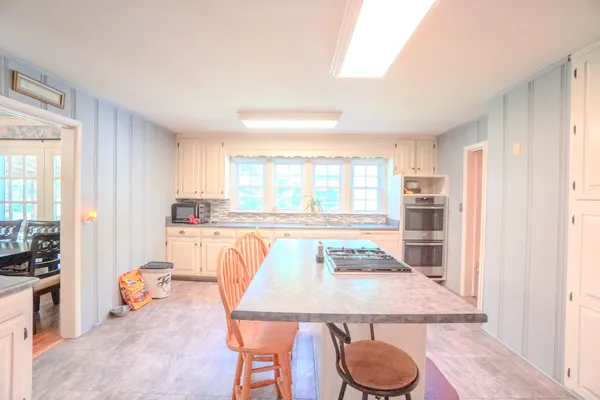 a dining room with furniture and window