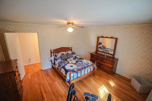 a bedroom with furniture and a window