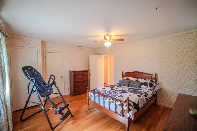 a bedroom with a bed and a chandelier