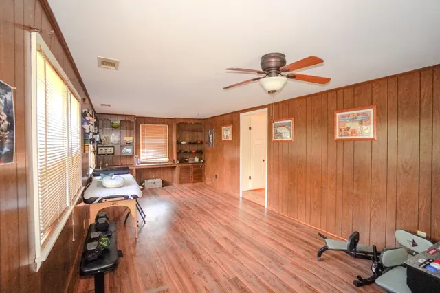 a view of a livingroom with furniture hardwood floor and a ceiling fan