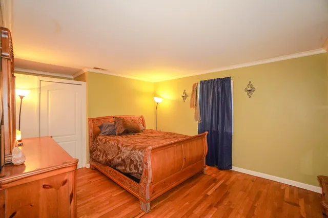 a bedroom with a bed and a dresser