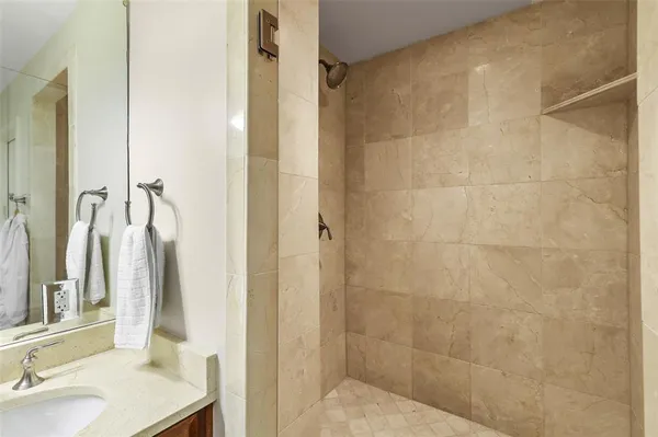 a bathroom with a sink and shower