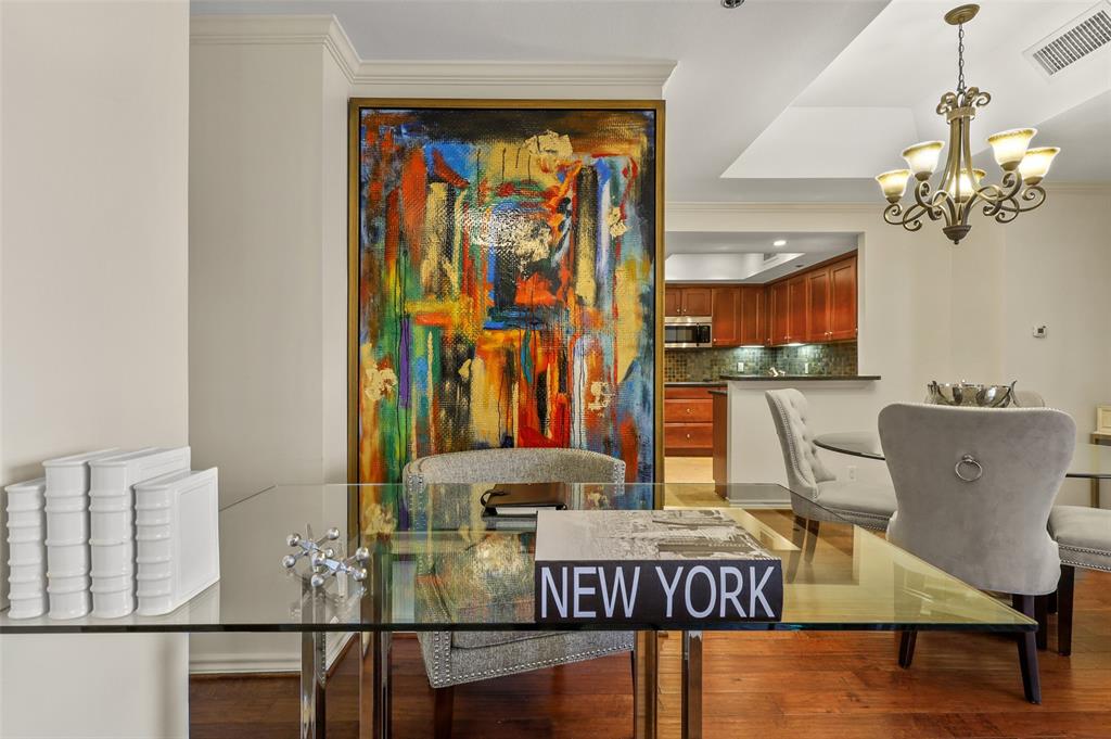 5909 Luther Lane, Unit 1102 Dallas, TX 75225 - Photo 22 of 31 a view of a dining room with furniture a chandelier and wooden floor