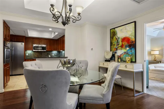 a view of a dining room with furniture wooden floor and a chandelier