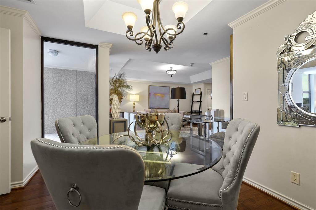 5909 Luther Lane, Unit 1102 Dallas, TX 75225 - Photo 5 of 31 a dining room with furniture a chandelier and wooden floor