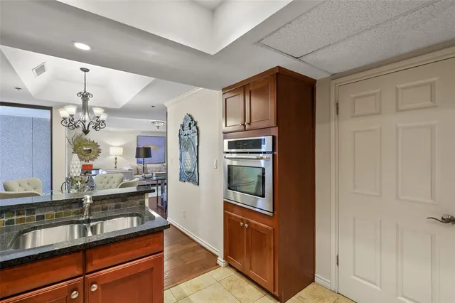 a kitchen with stainless steel appliances granite countertop a refrigerator and a sink