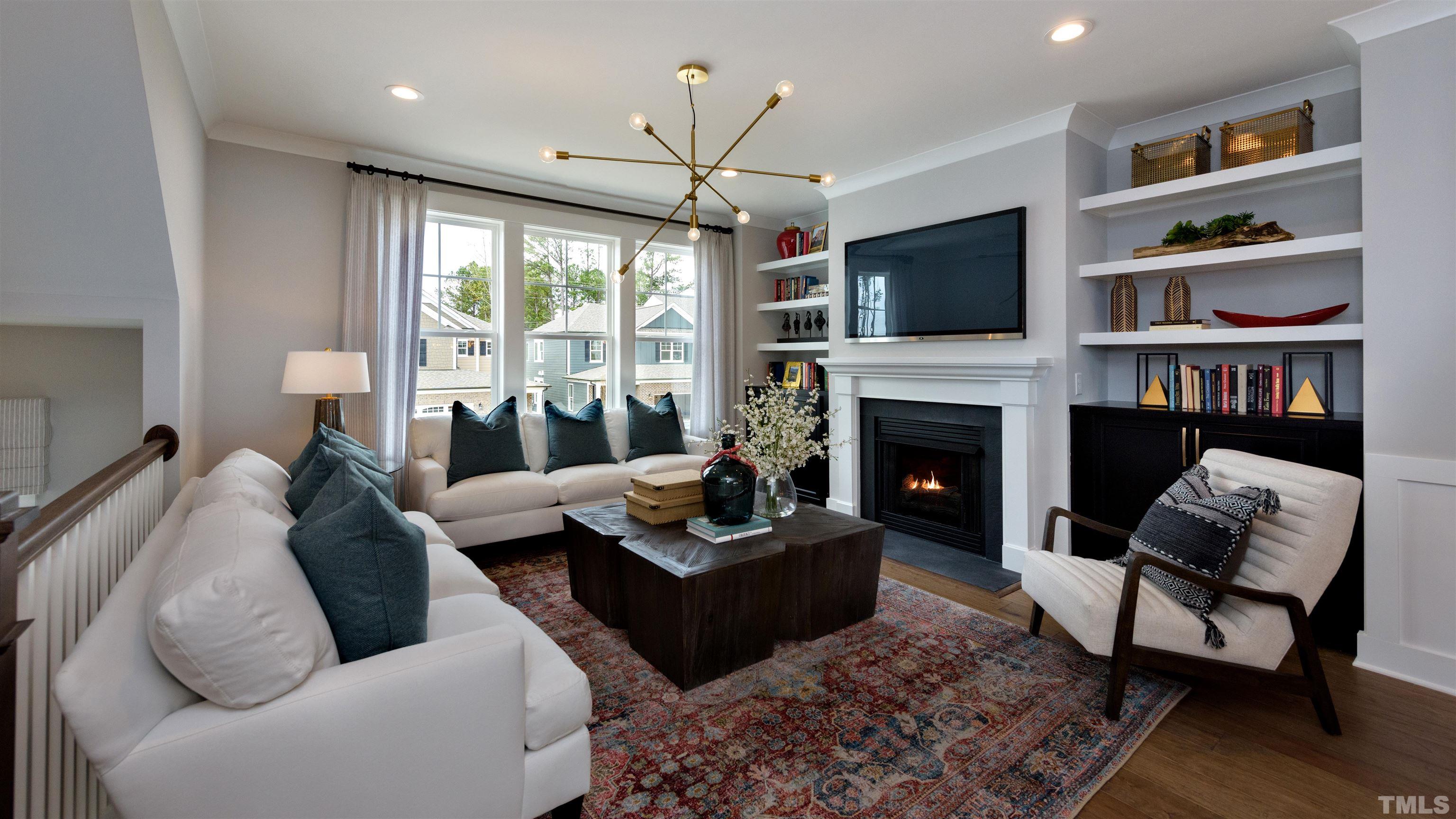 3245 Lynn Road, Unit 20 Raleigh, NC 27613 - Photo 10 of 26 a living room with furniture fireplace and flat screen tv