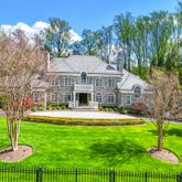 a front view of a house with a yard table and chairs