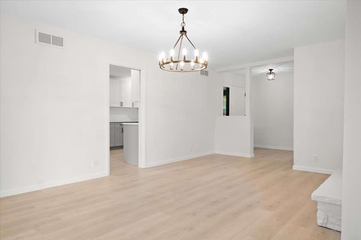 5 Ridgemont Road Normal, IL 61761 - Photo 13 of 58 an empty room with kitchen view and wooden floor