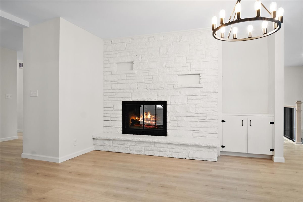 5 Ridgemont Road Normal, IL 61761 - Photo 15 of 58 a room with a fireplace and a wooden floor