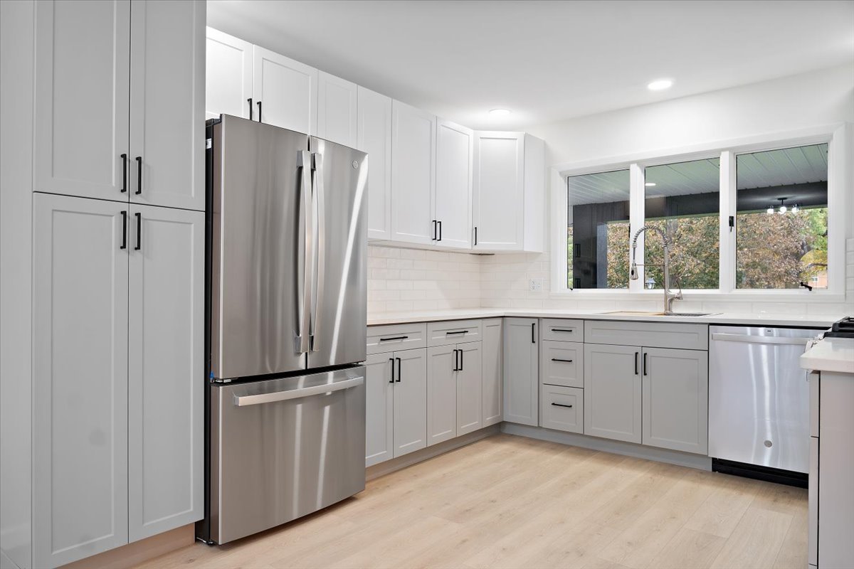 5 Ridgemont Road Normal, IL 61761 - Photo 18 of 58 a kitchen with white cabinets and stainless steel appliances