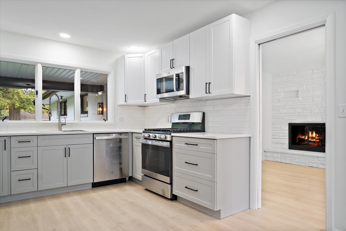 5 Ridgemont Road Normal, IL 61761 - Photo 19 of 58 a kitchen with stainless steel appliances granite countertop a stove and a sink