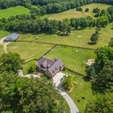 an aerial view of a house with a yard basket ball court and outdoor seating