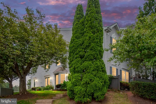 front view of a house with a yard and trees