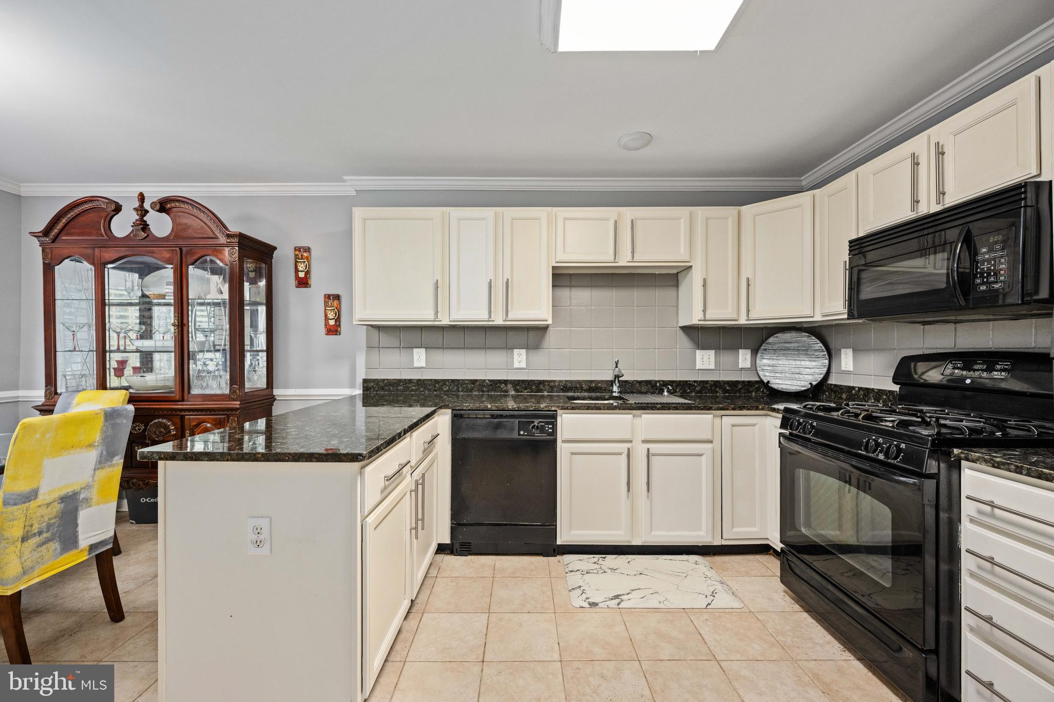9332 Wax Myrtle Way Manassas, VA 20110 - Photo 22 of 50 a kitchen with stainless steel appliances granite countertop a stove a sink and a microwave