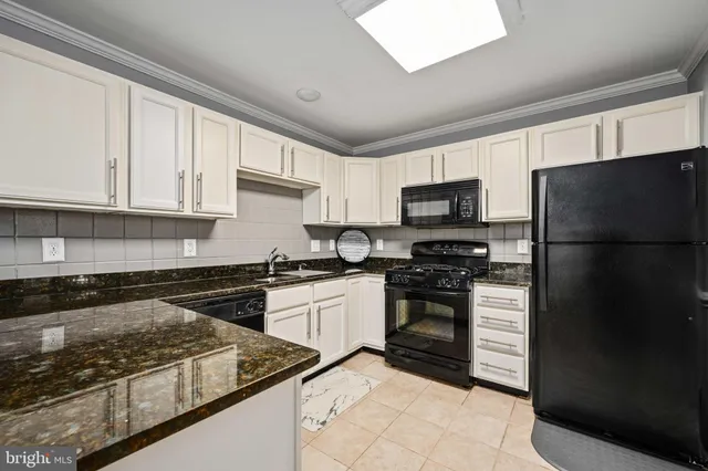 a kitchen with a stove a refrigerator and a sink