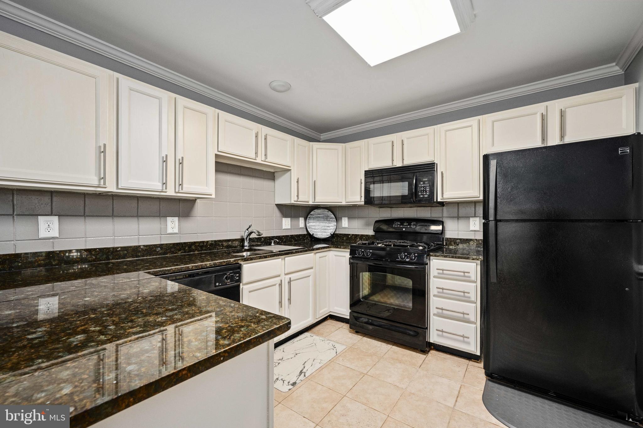 9332 Wax Myrtle Way Manassas, VA 20110 - Photo 23 of 50 a kitchen with a stove a refrigerator and a sink