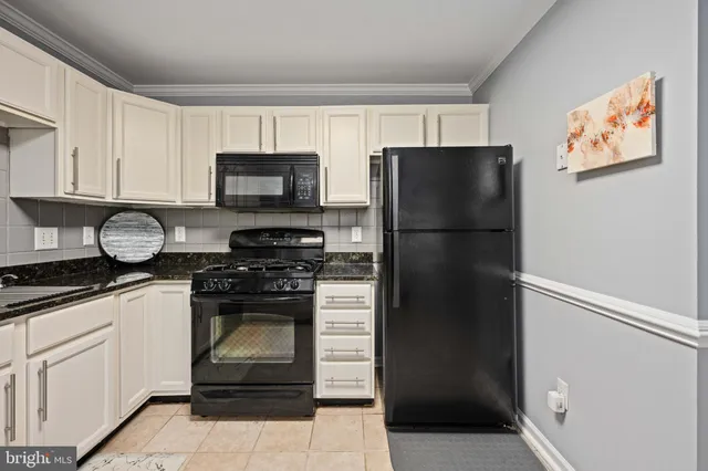 a kitchen with a refrigerator stove and sink