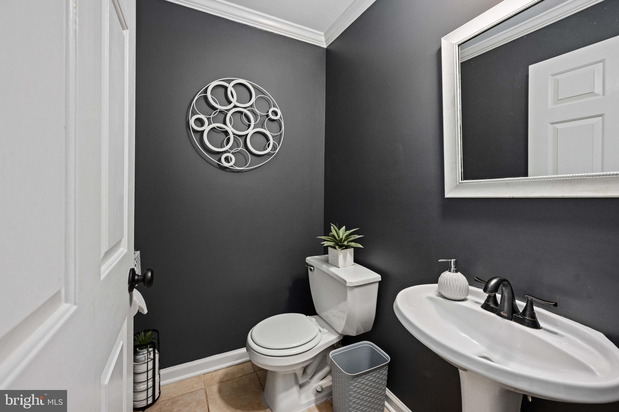 9332 Wax Myrtle Way Manassas, VA 20110 - Photo 34 of 50 a bathroom with a toilet sink and mirror