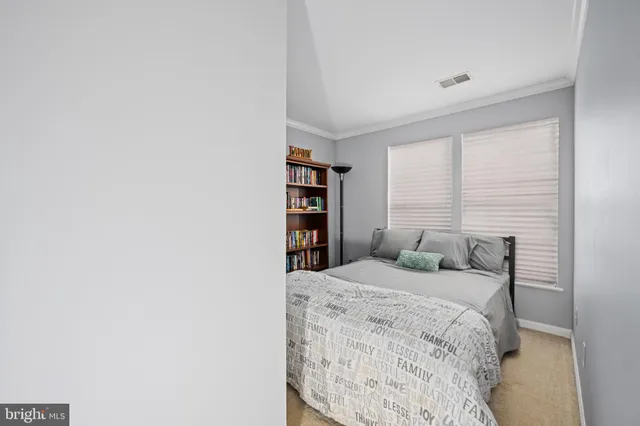 a bedroom with a bed and a book shelf