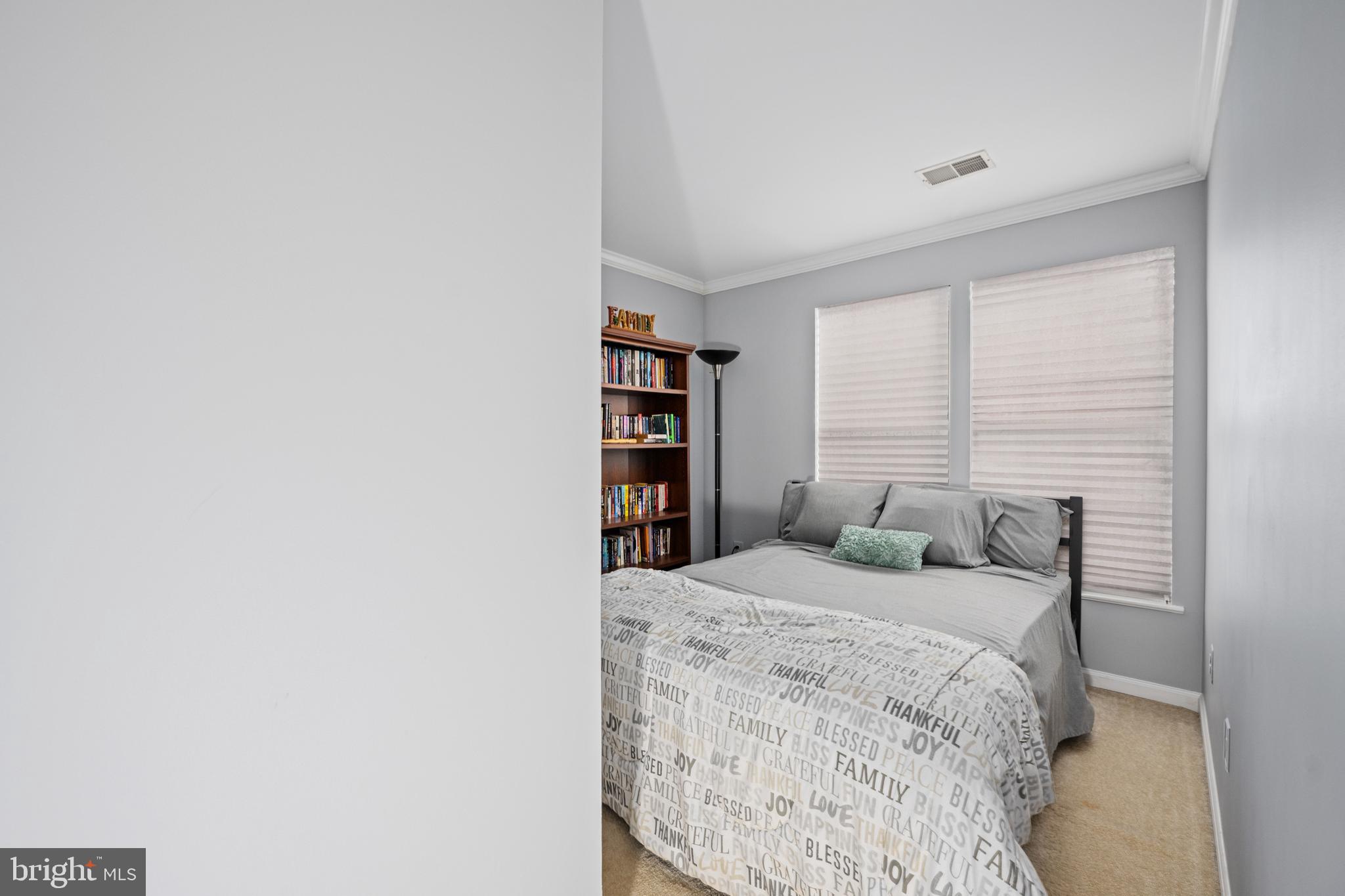 9332 Wax Myrtle Way Manassas, VA 20110 - Photo 38 of 50 a bedroom with a bed and a book shelf