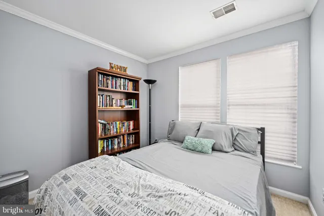 a bedroom with a bed and a book shelf