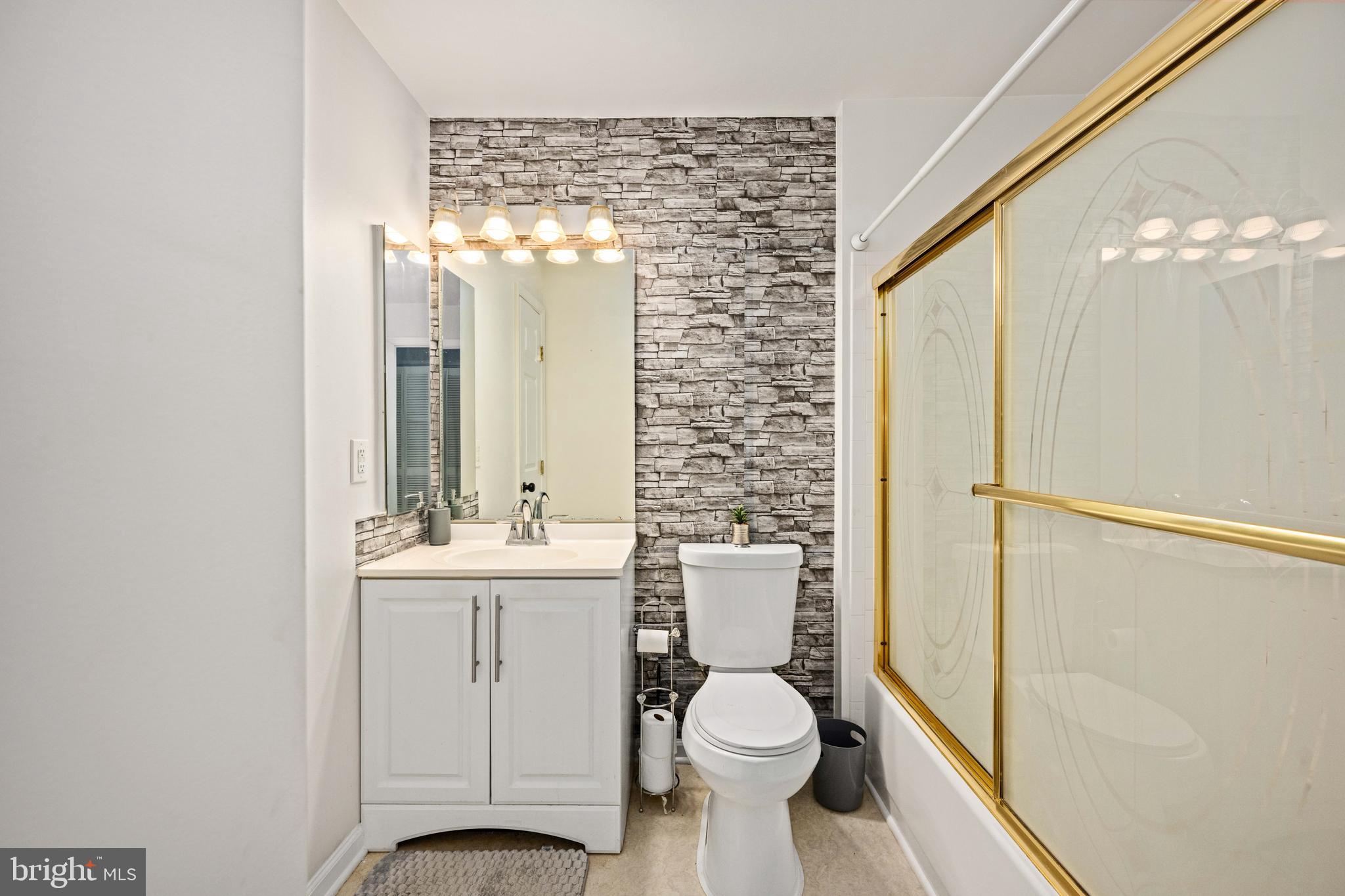 9332 Wax Myrtle Way Manassas, VA 20110 - Photo 40 of 50 a bathroom with a toilet a sink and a large mirror