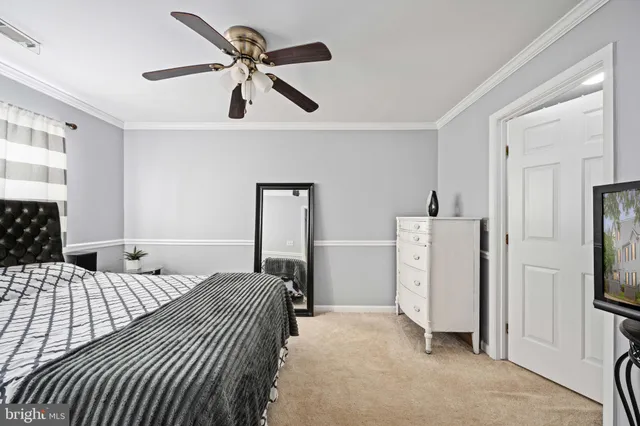 a bedroom with a bed and a refrigerator