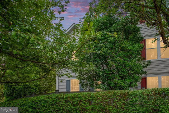 an aerial view of a house with a yard and tree s