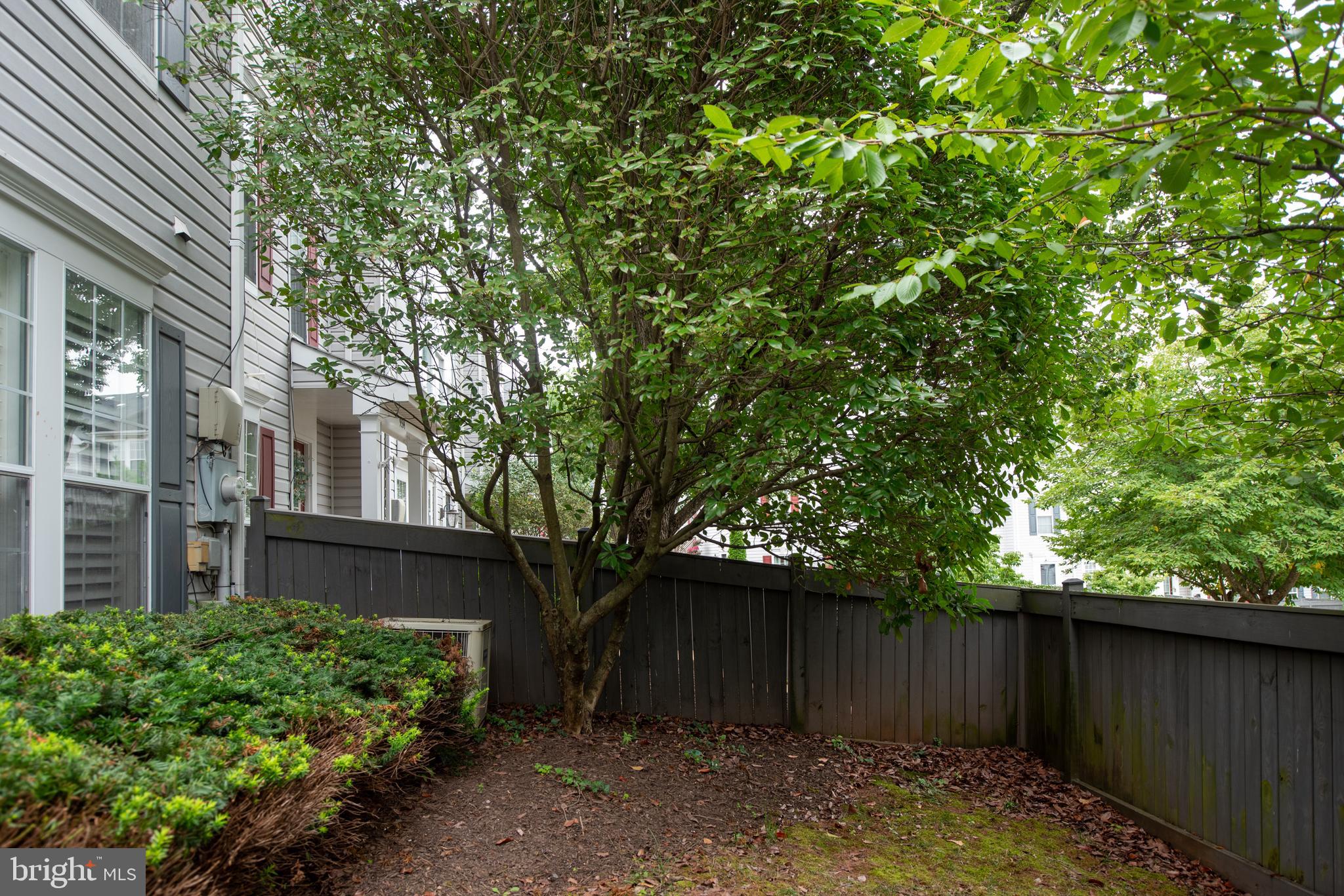 9332 Wax Myrtle Way Manassas, VA 20110 - Photo 49 of 50 a view of a house with a large tree and wooden fence