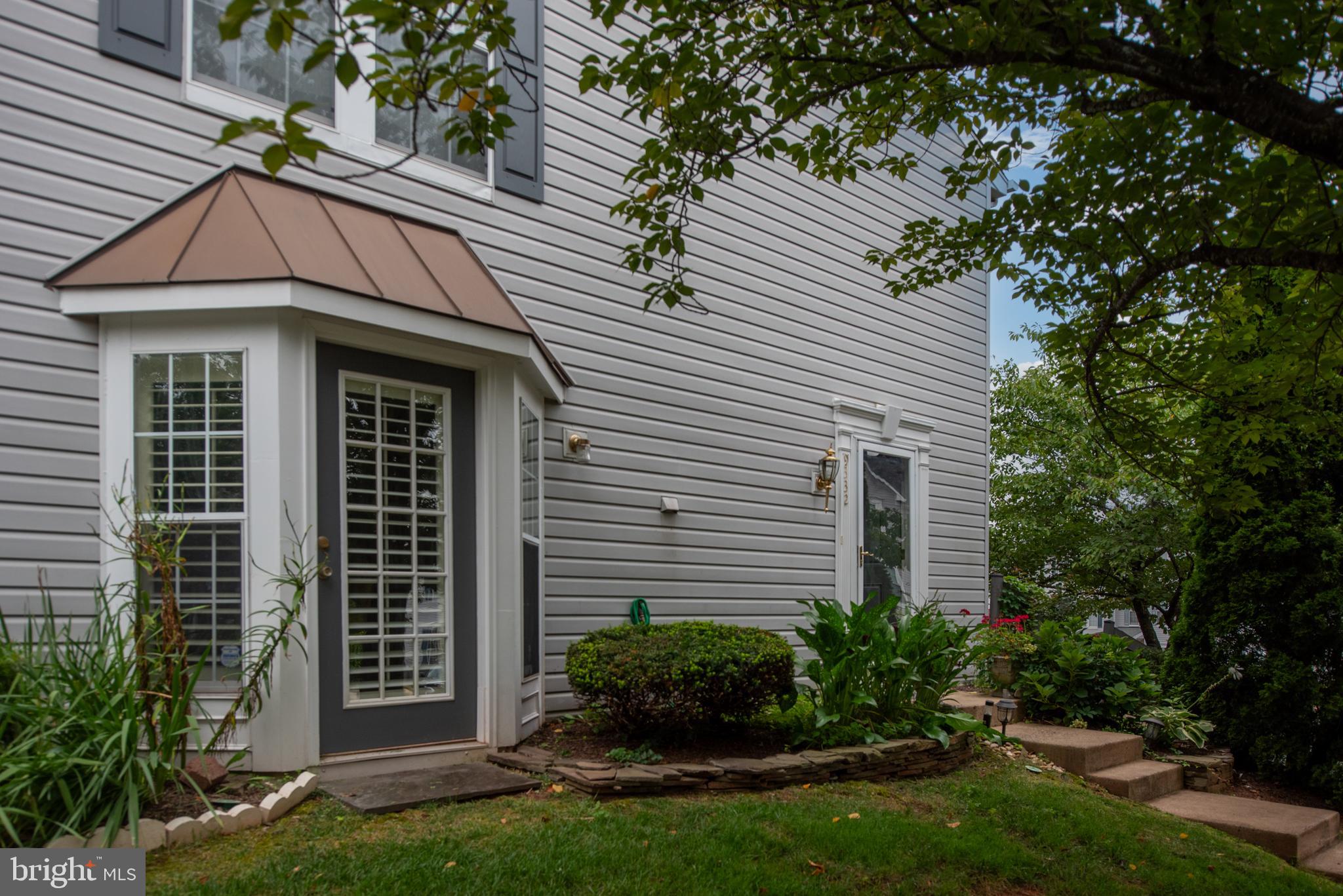 9332 Wax Myrtle Way Manassas, VA 20110 - Photo 5 of 50 a front view of a house with a garden
