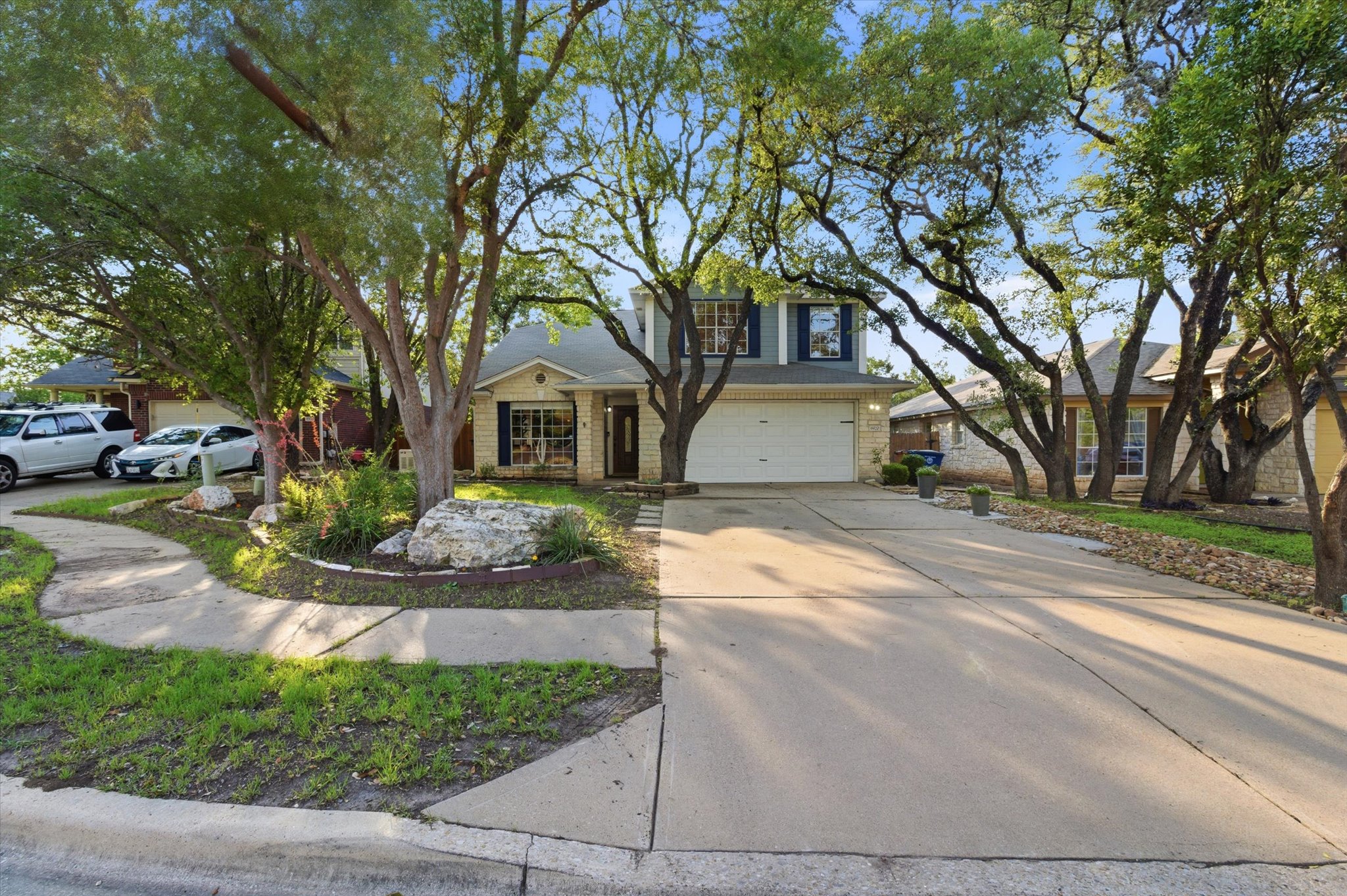 8920 West Hove Loop Austin, TX 78749 - Photo 35 of 39 Two-story residence featuring a stone and siding exterior with a prominent two-car garage