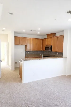 a kitchen with kitchen island cabinets and a sink