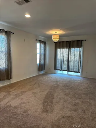 a view of a room with windows and chandelier
