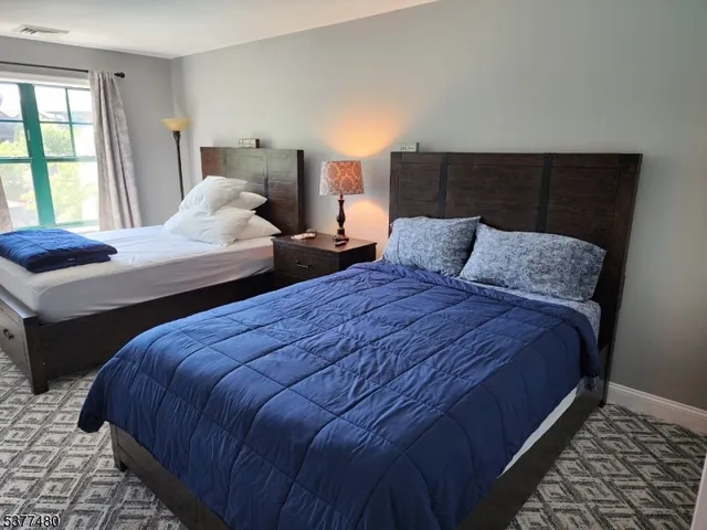 a bedroom with double bed and a window