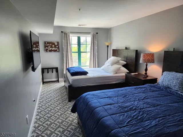 a bedroom with double bed and a window