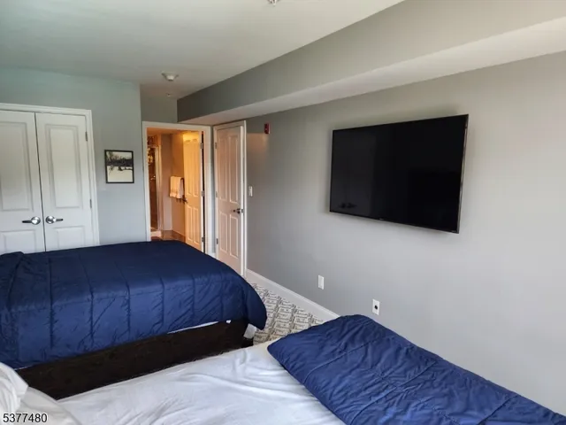 a bedroom with a bed and a television