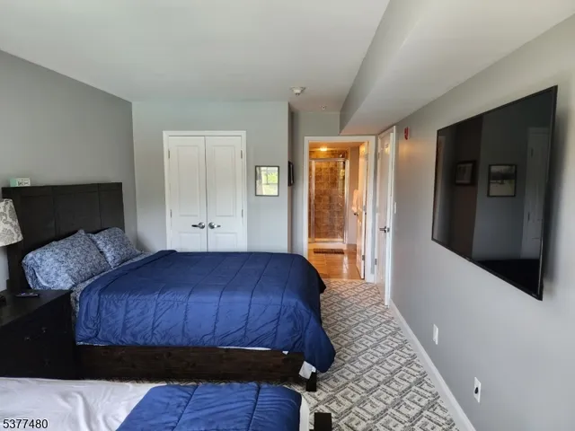 a bedroom with a bed and a television