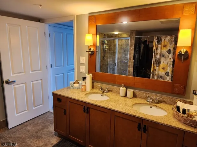 a bathroom with a double vanity sink and a mirror