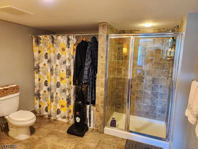 a bathroom with a toilet and a shower