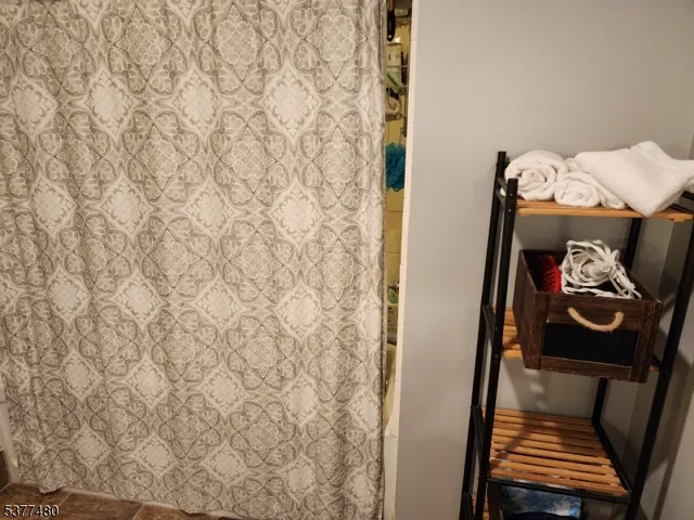 a view of a garden with lawn chairs under an umbrella