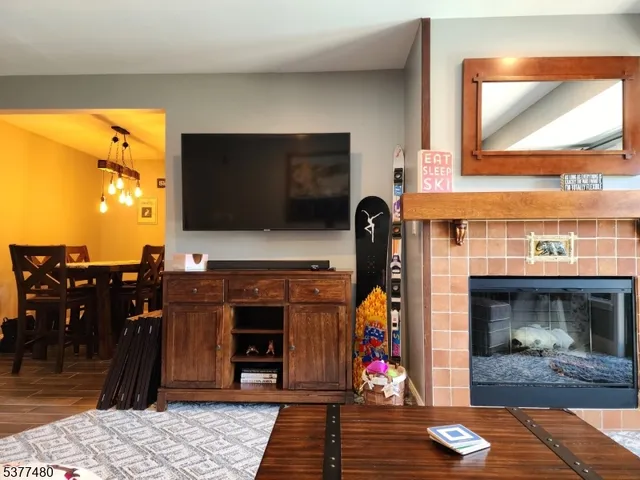 a view of living room with furniture and a fireplace