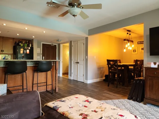 a living room with furniture a rug and a floor to ceiling window