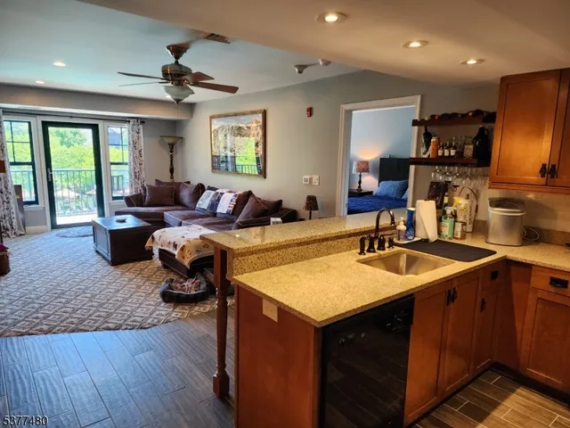 a living room with kitchen island granite countertop furniture and a sink