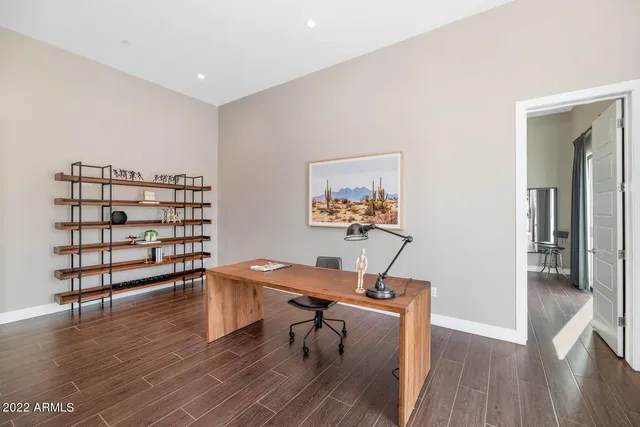 a bathroom with a toilet a sink a mirror and vanity