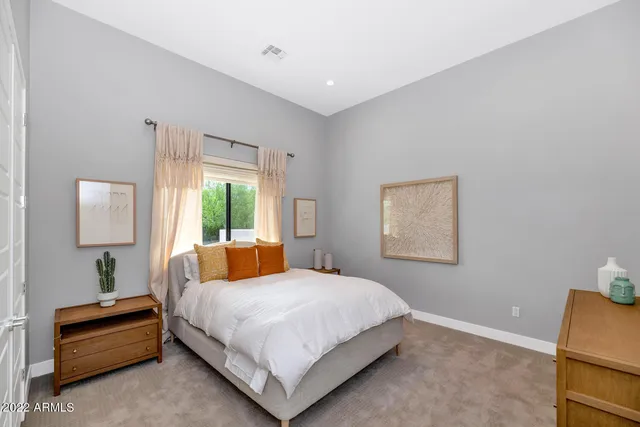 a view of house in front of a big yard with large trees