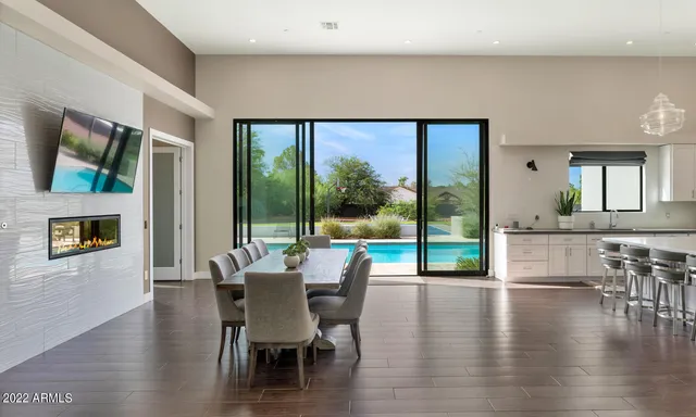 a dining room with wooden floor and furniture