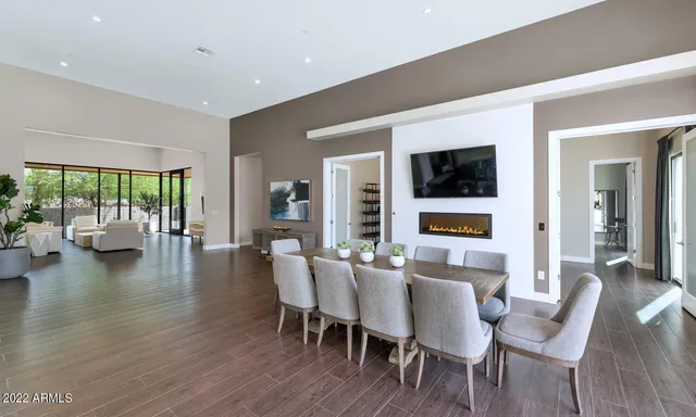 a dining room with furniture window and wooden floor