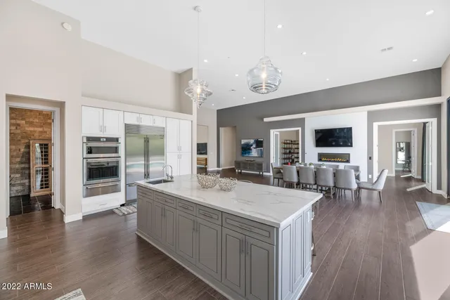 a spacious bedroom with a large bed and a flat screen tv