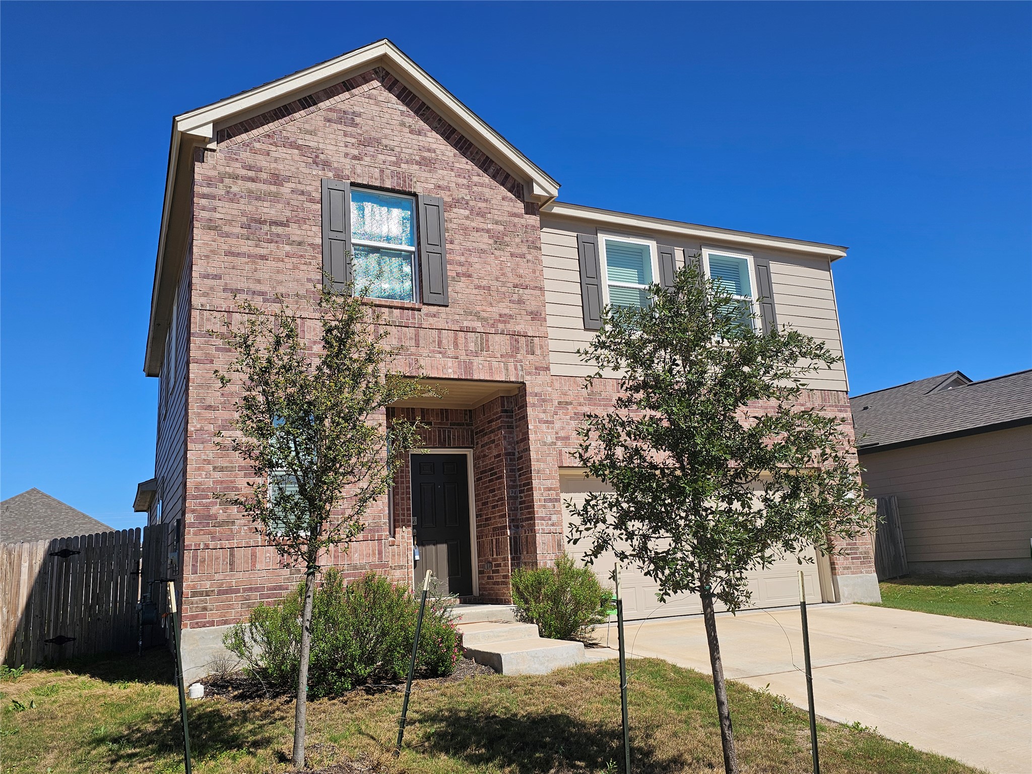 210 Summit Drive Lockhart, TX 78644 - Photo 1 of 21 a front view of a house with garden